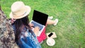 Young woman using laptop with blank screen while sitting on grass Royalty Free Stock Photo