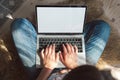 Young woman using laptop blank screen to work, sitting on the floor at home. Flexible hours and remote work. Royalty Free Stock Photo