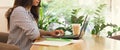 Young woman using laptop in cafe and drinking coffee Royalty Free Stock Photo