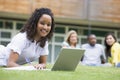 Young woman using laptop on campus Royalty Free Stock Photo