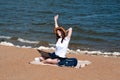 Young woman using laptop computer on a beach. Freelance work concept Royalty Free Stock Photo