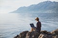 Young woman using laptop computer on a beach. Freelance work concept Royalty Free Stock Photo