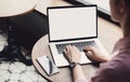 Young woman using laptop computer with blank white screen at cafe. Business woman working on computer in modern office. Royalty Free Stock Photo