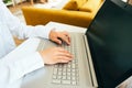 Young woman using laptop computer in the modern interior. Freelancer working remotely from home Royalty Free Stock Photo