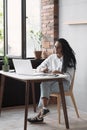 Young woman using laptop computer at office. Student girl working at home. Work or study from home, freelance, e-learning concept Royalty Free Stock Photo