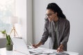 Young woman using laptop computer at office. Student girl working at home Royalty Free Stock Photo