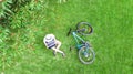 Young woman using laptop computer in park, student girl freelancer working and studying online outdoors on grass with bicycle Royalty Free Stock Photo