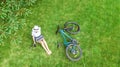 Young woman using laptop computer in park, student girl studying online sitting on grass with bicycle and laptop Royalty Free Stock Photo