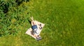 Young woman using laptop computer in park, student girl freelancer working and studying online outdoors sitting on grass Royalty Free Stock Photo