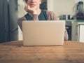 Young woman using laptop and daydreaming Royalty Free Stock Photo