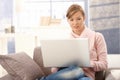 Young woman using laptop at home Royalty Free Stock Photo