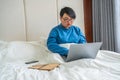 Young woman using laptop in hotel room Royalty Free Stock Photo