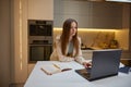 Young woman using laptop working or studying from home Royalty Free Stock Photo