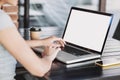 Young woman using laptop outdoor. Student girl working at a cafe. Blank white empty computer screen monitor. Royalty Free Stock Photo