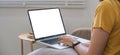 Young woman using laptop screen blank, mockup lying on the sofa at home Royalty Free Stock Photo