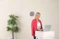 Young woman using laptop at stand up workplace Royalty Free Stock Photo