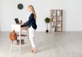 Young woman using laptop at stand up workplace Royalty Free Stock Photo