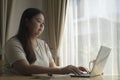 Young woman using laptop, surfing internet, working online at home Royalty Free Stock Photo