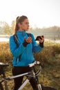 Young woman using mobile phone for navigation during bicycle ride