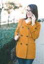 Young woman using mobile phone outdoors calling Royalty Free Stock Photo