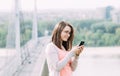 Young woman using mobile phone outdoors in a city Royalty Free Stock Photo