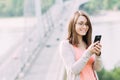 Young woman using mobile phone outdoors in a city Royalty Free Stock Photo