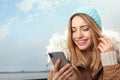 Young woman using mobile phone outdoors. Royalty Free Stock Photo