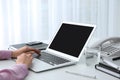 Young woman using modern laptop at table Royalty Free Stock Photo