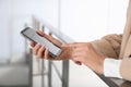 Young woman using modern smartphone indoors