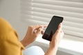 Young woman using modern smartphone indoors Royalty Free Stock Photo