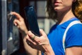 Young woman using public telephone Royalty Free Stock Photo