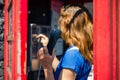 Young woman using public telephone Royalty Free Stock Photo