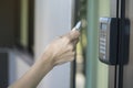 Young woman using RFID tag key to open the door Royalty Free Stock Photo