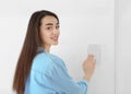 Young woman using security system indoors Royalty Free Stock Photo