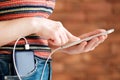 Woman using smart phone while charging on the power bank. Royalty Free Stock Photo