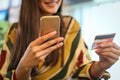 Young woman using smart phone and credit card. Royalty Free Stock Photo