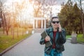 Young woman using a smart phone waling in the park Royalty Free Stock Photo