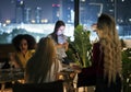 Young woman using a smartphone at a dinner night having no inter