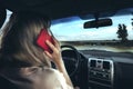 Woman using smartphone while driving car Royalty Free Stock Photo