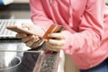 Young woman using smartphone and holding credit card at the kitchen Royalty Free Stock Photo