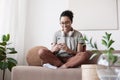 Young woman using smartphone at home. Student girl texting on mobile phone in her room. Communication, connection, modern people Royalty Free Stock Photo