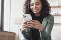 Young woman using smartphone at home. Student girl texting on mobile phone in her room. Communication, leisure lifestyle concept Royalty Free Stock Photo