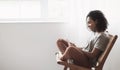 Young woman using smartphone at home. Student girl texting on mobile phone in her room. Online communication and leisure concept Royalty Free Stock Photo