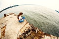 Young woman using smartphone sitting on an old pier Royalty Free Stock Photo