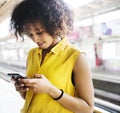 Young woman using a smartphone on the subway station Royalty Free Stock Photo