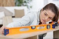 Young woman using spirit level Royalty Free Stock Photo