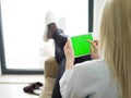 Young woman using tablet computer in front of fireplace Royalty Free Stock Photo