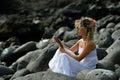 Young woman using tablet on rocky beach Royalty Free Stock Photo