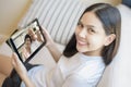 young woman is using tablet to Video calling or Webcam to grandparent ,  telecommunications technology , parenthood family Royalty Free Stock Photo