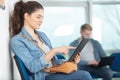 young woman using tablet in waiting room Royalty Free Stock Photo